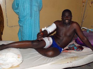 A man speaks on his hospital bed on November 25, 2014 about injuries sustained following double female suicide bomb attacks that killed 45 people in Maiduguri, northeastern Nigeria. More than 45 people were killed when two female suicide bombers blew themselves up in a crowded market in northeast Maiduguri
