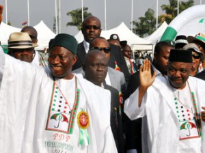 Nigeria's president Goodluck Jonathan (L) and vice president Namadi Sambo wave to supporters during a presidential primary in Abuja, on December 10, 2014. Jonathan is expected to be formally endorsed as the PDP candidate, with no other challengers, for the next year presidential elections. AFP PHOTO