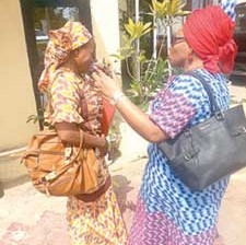 Madam Omokoro(left) being consoled byProphetess Robertson