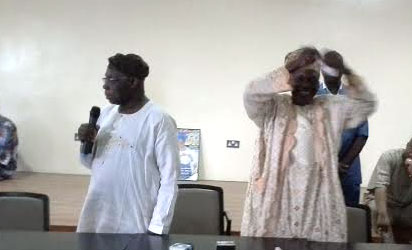 OBASANJO—Ex-President Obasanjo (left) watches as Alhaji Usman Oladunjoye tears the PDP membership card. Right: Obasanjo's card after it was torn, yesterday.