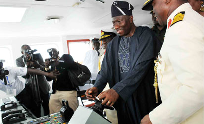 President Jonathan testing one of the warships after inauguration, while the Chief of Naval Staff, Vice Admiral. Jibrin Usman watch.