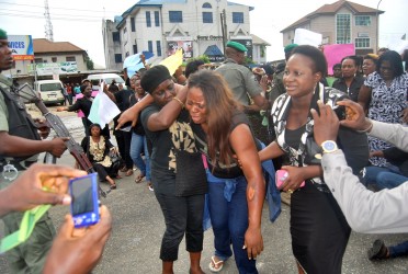 A Female APC Supporter allegedly beaten up at the Polls on Saturday in Rivers State when A Mamoth Delegation of Women led by the Rivers State Commissioner for Women Affairs Joe-eba West  tried to access the INEC Headquaters in Rivers State to Lodge their Complaints Over the Presidential and National Assembly Elections in the State. Photo: Nwankpa Chijioke