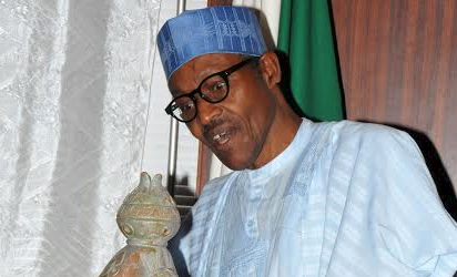 President Muhammadu Buhari admiring an art work presented to him