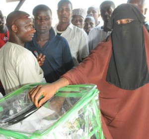 A woman in Purdah casting her votes during the Gubernatorial and State Assembly Elections in Minna, Niger State. Photo by Abayomi Adeshida