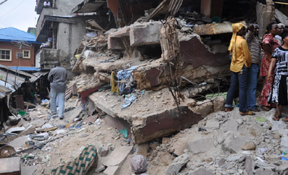 Sympathisers and rescue workers at 4, Mogaji Lane off Johnson Street, behind SCOA Building, Idumota, Lagos where a four-storey building collapsed, Tuesday night. 10 persons were killed in the collapsed structure while several others remained trapped in it yesterday. Photo: Bunmi Azeez