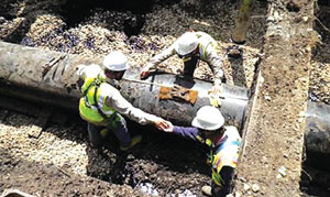 *Workers fixing a broken oil pipeline.