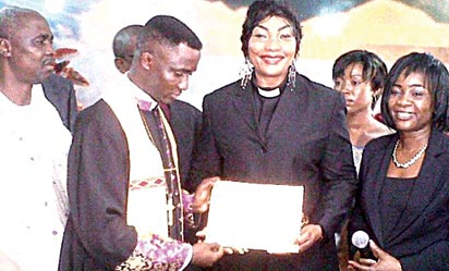 *Eucharia displaying her certificate after her ordnation