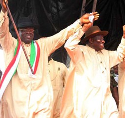 President Goodluck Jonathan flanked by Vice President Namadi Sambo and the Bayelsa State PDP Gubernatorial Candidate, Mr. Seriake Henry Dickson (l) while the First Lady, Dame Patience Jonathan also grabs the hands of the wife of the candidate, Mrs. Seriake Dickson as they danced round the arena during the grand finale of the PDP Governorship Campaign at the Samson Siasia Stadium, Yenagoa, Bayelsa State. Photo by Abayomi Adeshida