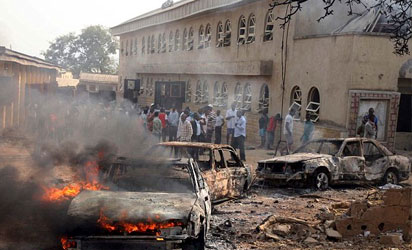File Photo: A car burns at the scene of a bomb explosion at St. Theresa Catholic Church at Madalla, Suleja, on December 25, 2011.