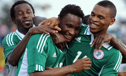 Super Eagles midfielder, Mikel Obi being mobbed by his team mates