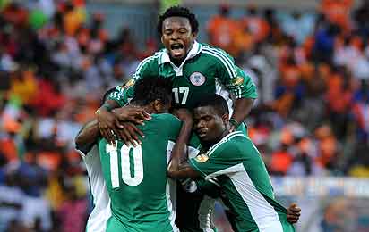 Nigeria's forward Sunday Mba (hidden) is congratulated by teammates after scoring a goal during the African Cup of Nation 2013 quarter final football match Ivory Coast vs Nigeria, on February 3, 2013 in Rustenburg. AFP PHOTO / ALEXANDER JOE