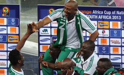 Champion ..... Eagles lift their Coach Stephen Keshi after the team won the Cup yesterday. Photo: AFP