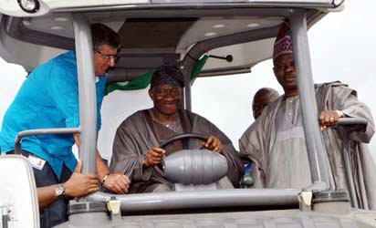 President Goodluck Jonathan (m) being assisted by Mr Hartlied Harald, Asphalt Supervisor, Julius Berger (left) and Gov Ibikunle Amosun of Ogun state, operating construction equipment during the flag off ceremony of Lagos Ibadan Expressway Reconstruction  in Sagamu  photo by Joe Akintola