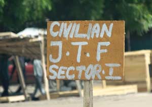 A sign near a checkpoint of a vigilante group reads Civilian J.T.F or Civilian Joint Task Force  in Maiduguri,. Young men and women have in recent weeks formed vigilante groups, hunting down Boko Haram Islamists who have sneaked back into the city following a military offensive on their camps on the Nigerian border with Niger, Chad and Cameroon with remarkable success. AFP PHOTO 
