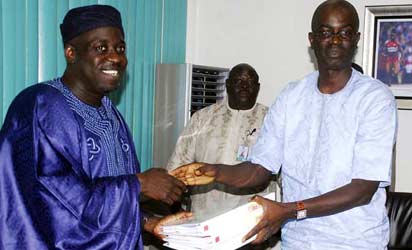 PRESENTATION: Chairman of the ministerial panel on Super Eagles bonus row, Segun Adeniyi (r) presents the report of their findings to Sports Minister, Bolaji Abdullahi in Abuja Thursday. Photo Gbemiga Olamikan