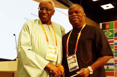 IAAF boss Lamine Diack (l) presents Solomon Ogba, AFN president, with a medal of recognition in Moscow.