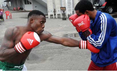Isaac Ekpo (L) Super Middle Weight Boxing Champion with his Coach, Seidu Kalifa, in training  at the National Stadium In Lagos recently. 