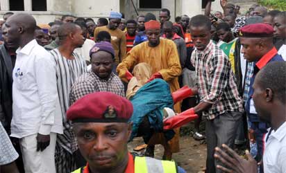 RESCUE OPERATORS EVACUATING REMAINS OF PEOPLE KILLED IN AN UNCOMPLETED BUILDING BY UNKNOWN GUNMEN AT APO ZONE E IN ABUJA ON FRIDAY (20/9/13).