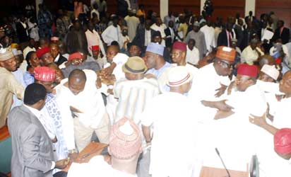 ROWDY REPS—Members of the House of Representatives during the brawl in the House, yesterday. Photos: Gbemiga Olamikan.