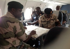 File photo strategizing: The Chief of Army Staff, Lt-Gen Kenneth Minima (left); his Air Force counterpart, Air Marshal Adesola Amosu (middle) and General Officer Commanding 3rd Division, Nigerian Army, Maj. Gen John Zaruwa, aboard a Nigerian Air Force plane strategising with the aid of maps in the ongoing counter-terrorist operations in Borno, Yobe and Adamawa states, during a visit to the area, weekend.