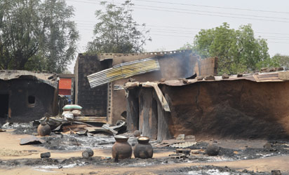 File : NIGERIA, Maiduguri : This photo shows razed homes in Mainok, outside Maiduguri, Borno State, Nigeria, on March 6, 2014. At least 74 people were killed in attacks on March 1, 2014 in villages near Maiduguri, blamed on Boko Haram militants, taking the overall death toll this year beyond 300, with no apparent end in sight to the carnage. Gunmen dressed in military fatigues and armed with powerful assault rifles, rocket-propelled grenades and explosives laid siege to the village of Mainok, killing 39. AFP PHOTO 