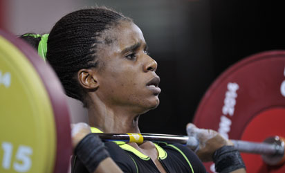 •Golden lift... Amahala lifts for gold in Glassgow Friday. Photos: AFP