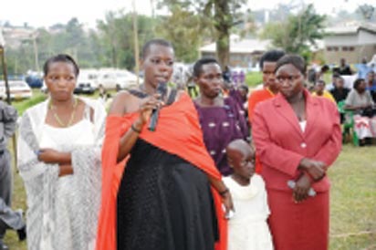 Gloria Tumwijuke (with microphone), Alice Ngonzi Isoke (folding hands in red dress), Diana Alinaitwe (behind Alice), Mrs Isoke (Alice’s mother), an unidentified health worker(on Gloria’s right) and a granddaughter to Mrs Isoke – all Ebola survivors narrating their ordeal at Kagaadi Hospital during the function to officially declare Uganda Ebola free. Photo courtesy WHO