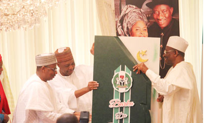 President Goodluck Jonathan (r) receiving a greeting card from Vice President Namadi Sambo; FCT Minister, Senator Bala Mohammed and the Minister of State FCT, Oloye Olajumoke Akinnjide during Eid-il-Fitri homage paid the President by residents of the FCT led by Vice President Namadi Sambo at the President's Residence, State House, Abuja. Photo by Abayomi Adeshida