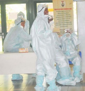 HEALTH PERSONNEL IN PROTECTIVE KITS AT THE NATIONAL HOSPITAL IN ABUJA ON TUESDAY (12/8/14).