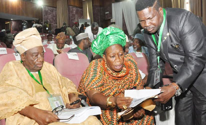 .FROM LEFT:FORMER ATTORNEY GENERAL AND MINISTER OF JUSTICE, JUCTICE RECHARD AKINJIDE;PRESIDENT MARKET WOMEN ASSOCIATION, CHIEF FELICIA SANNI GOING THROUGH DOCUMENT WITH HUMAN RIGHTS LAWYER, MIKE OZEKHOME (SAN) AT THE NATIONAL CONFERENCE IN ABUJA ON WEDNESDAY (13/8/14).