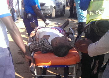 A survivor of the Synagogue Church Of All Nations building collapse being wheeled out