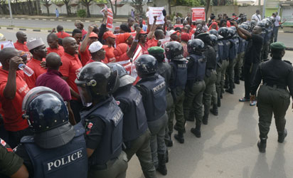 File: Policewomen block supporters of the #BringBackOurGirls campaign, who ask for the release of the 219 Chibok schoolgirls kidnapped by Boko Haram militants, from marching to the president's official residence in the Nigerian capital Abuja on October 14, 2014. Nigerian police on Tuesday blocked supporters of 219 schoolgirls kidnapped by Boko Haram militants from marching on the president's official residence on the six-month anniversary of the abduction. A wall of female officers in full riot gear formed the first line of a barricade in front of less than 100 members of the Bring Back Our Girls campaign, preventing them from setting out. AFP PHOTO
