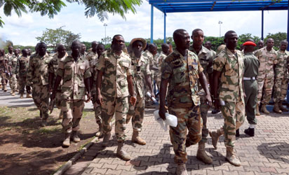 Soldiers tasked with fighting Boko Haram militants arrive to face trials for mutiny in Abuja on October 2, 2014. Nearly 100 soldiers tasked with fighting Boko Haram militants in Nigeria's far northeast appeared at a military court martial on Thursday, facing a range of charges including mutiny. The hearing comes just weeks after a tribunal sentenced 12 soldiers to death following their conviction for shooting at their commanding officer in the Borno state capital, Maiduguri, in May. AFP PHOTO