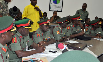 Members of the court martial sit during the inauguration to try soldiers accused of mutiny tasked with fighting Boko Haram militants in Abuja on October 2, 2014. Nearly 100 soldiers tasked with fighting Boko Haram militants in Nigeria's far northeast appeared at a military court martial on Thursday, facing a range of charges including mutiny. The hearing comes just weeks after a tribunal sentenced 12 soldiers to death following their conviction for shooting at their commanding officer in the Borno state capital, Maiduguri, in May. AFP PHOTO