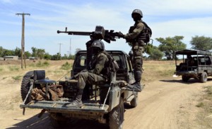 File: Cameroonian soldiers patrol on November 12, 2014 in Amchide, northern Cameroon, 1 km from Nigeria. The city was raided by Islamists from Nigeria's Boko Haram, killing eight cameroonian soldiers and leading the population to flee on October 15, 2014, before another six coordinated attacks that killed at least three civilians in the remote north of the country, on November 9, 2014. Boko Haram's five-year insurgency in neighboring Nigeria has left thousands dead, and the Islamists have occasionally carried out attacks over the border. Cameroon has deployed more than 1,000 soldiers in the extreme northeast of the country to counter the Islamist threat. AFP PHOTO