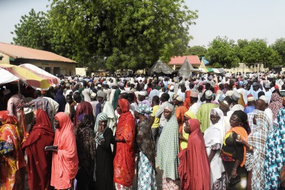 Voters from an Internally Displaced People (IDP) camp in Maiduguri queue to get registered for Nigeria's presidential elections in Maiduguri on March 28, 2015. Polling stations opened in Nigeria today, the electoral commission said, as voters went to the polls to elect a new president in what is being seen as the closest campaign in the country's history.  AFP PHOTO 