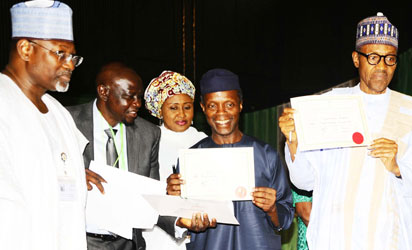 President-Elect, General Muhammadu Buhari (right); his Vice President-Elect, Professor Yemi Osinbajo (2nd right) displaying their Certificates of Return after receiving it from the Chairman, Independent National Electoral Commission (INEC), Professor Attahiru Jega (left) at the National Conference Centre, Abuja on Wednesday