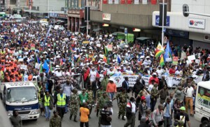 Thousands of people take part in the "peace march" against xenophobia in Durban, South Africa, on April 16, 2015. South African President Jacob Zuma on April 16 appealed for the end of attacks on immigrants as a wave of violence that has left at least six people dead threatened to spread across the country. In the past two weeks, shops and homes owned by Somalis, Ethiopians, Malawians and other immigrants in Durban and surrounding townships have been targeted, forcing families to flee to camps protected by armed guards. AFP PHOTO
