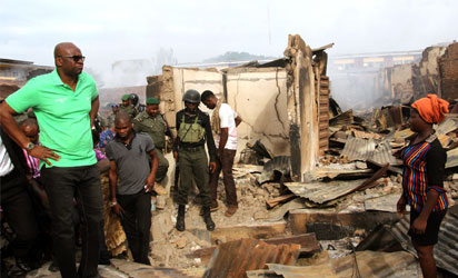 Ekiti State Governor, Mr. Ayodele Fayose, inspects the Oja Oba market in Ado-Ekiti  torched  hoodlums on Friday