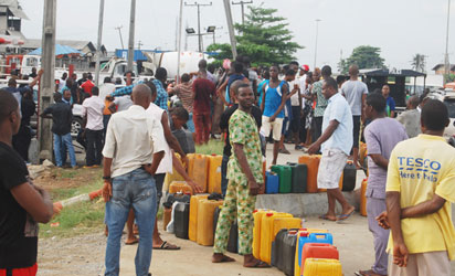 Long queue of jerry cans at a petrol station as fuel scarcity bites harder, yesterday. Photo: Joe Akintola, Photo Editor.