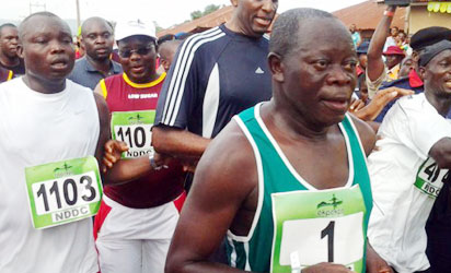 Governor Adams Oshiomhole (1) taking part in the Okpekpe Road Race