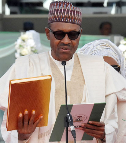 Nigerian President Mohammadu Buhari swears to an oath during his inauguration at the Eagles Square in Abuja, on May 29, 2015. Buhari, 72, defeated Goodluck Jonathan in March 28 elections -- the first time in Nigeria's history that an opposition candidate had beaten a sitting president. AFP PHOTO