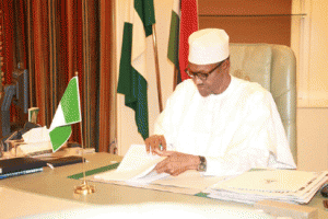 President Muhammadu Buhari attending to some files in his office as he resumed duties at the Presidential Villa, Abuja. Photo by Abayomi Adeshida