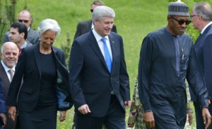 (LtoR) Iraq's Prime Minister Haider al-Abadi, IMF Managing Director Christine Lagarde, Canadian Prime Minister Stephen Harper, and Nigeria's President Muhammadu Buhari, arrive for the family photo of G7 leaders and outreach talks participants during the G7 Summit at the Schloss Elmau castle resort near Garmisch-Partenkirchen, in southern Germany on June 8, 2015. AFP PHOTO
