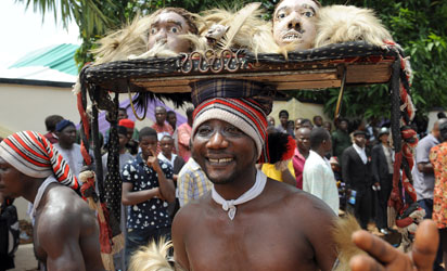 (FILES)- A March 2, 2012 file photo shows an Ohafia cultural troupe entertaining bystanders during the burial of Nigeria's secessionist leader Odumegwu Ojukwu at his native Nnewi country home, in Anambra State eastern Nigeria. Odumegwu Ojukwu, who championed the campaign for an independent Republic of Biafra in eastern Nigeria in the 1960s culminating in a 30-month civil war which left more than a million dead was buried at his Nnewi family home in Anambra State. Its name is synonomous with the declaration of independence and updates on the brutal conflict that followed, but nearly 50 years after Nigeria's civil war, Radio Biafra is again making headlines. AFP PHOTO