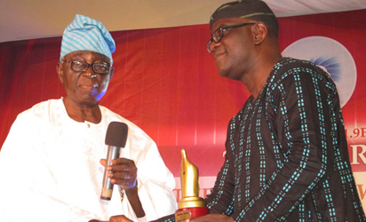plaudits for amuka: Mr. Gbenga Adefaye, Vanguard Newspaper's GM/Editor-In-Chief (right) receiving an award on behalf of Mr Sam Amuka, Vanguard''s Publisher from Hon. Justice Demola Bakare (retd) at the Rockcity FM 101.9 awards ceremony held at DLKE Events Centre, along Abiola way, Leme, Abeokuta. Photo by Wunmi Akinola.