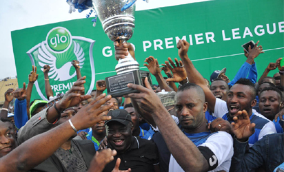 Glo Premier League Trophy Presentation... From left, Chairman of the League Management Company, Mallam Shehu Dikko, Governor of Abia State, Dr. Okezie Ikpeazu, NFF 1st Vice President, Barrister Seyi Akinwumi and Enyimba captain, Chinedu Udoji at the Teslim Balogun Stadium in Lagod.