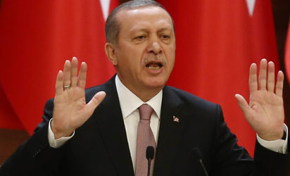 Turkish President Recep Tayyip Erdogan delivers a speech during a mukhtars meeting at the presidential palace on November 26, 2015 in Ankara. President Recep Tayyip Erdogan on November 26 said Turkey does not buy any oil from Islamic State, insisting that his country's fight against the jihadist group is "undisputed". AFP PHOTO