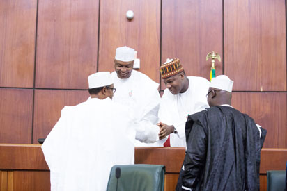 Senate President, Bukola Saraki; Speaker, House of Representative, Dogara exchanging pleasantries with President Buhari during the presentation of N6.08trn 2016 budget to NASS, on December 22, 2015.