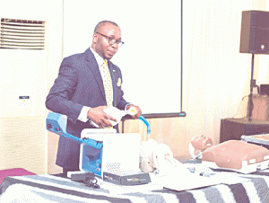 PRESENTATION- Dr. Dayo Olakulehin demonstrating his innovative invention, the D-Box , a portable battery operated ventilator, during a public presentation in Lagos last week.